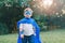 Preschool Caucasian child boy playing superhero in green costume