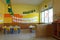 Preschool classroom with chairs and table with drawings