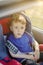 Preschool cute 3-4 years old boy sitting in safety car seat and crying during family travel by car, bad mood, negative emotion,