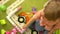 Preschool cute toddler playing with multi coloured building blocks in kindergarten. Education in nursery school