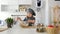 Preschool girl baker kneads the dough with a large wooden spoon in a bowl