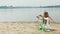 preschool girl with dances a  gymnastic ribbon on a sandy beach. Summer, dawn