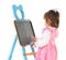 Preschool girl draws on childrens board