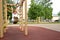 Preschool girl is engaged on the rings on the playground. sports lifestyle concept. walk in the fresh air. children play on the