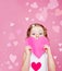 Preschool girl holding paper heart