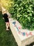 Preschool girl painting with watercolor paints on backyard of house. Child kid playing drawing writing word love and hearts for