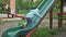 Preschool girl tries to climb up on children\'s slide