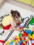 Preschool girl who build towers with plastic cubes