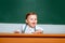 Preschool kids. Learning and education concept. Back to school. Funny preschooler on blackboard background.