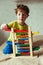 Preschooler baby learns to count. Cute child playing with abacus toy. Little boy having fun indoors at home
