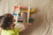 Preschooler baby learns to count. Cute child playing with abacus toy. Little boy having fun indoors at home, kindergarten or day c