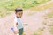 Preschooler boy blows big soap bubbles in a field on a bright sunny day