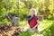 Preschooler boy digging shovel in backyard on summer sunny day. Little gardener. Seasonal working in garden