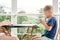 Preschooler boy drinks mug of warm milk in early morning