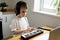 Preschooler boy in headphones learns to play the musical keyboard online. Distance learning to play the piano. Online