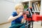 Preschooler boy playing with big construction building crane toy at home. Kids leisure activity. Entertainment for children