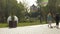 A preschooler boy in a protective helmet rides in the park. Summer