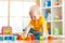 Preschooler child playing with colorful toy blocks. Kid playing with educational wooden toys at kindergarten or day care center.