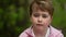 Preschooler child at street in daytime, closeup portrait