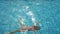 Preschooler child swims and dives in an empty pool