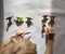 Preschooler draws contrasting shadows from toy little dinosaurs standing in a row