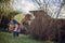 Preschooler girl helps to cut branches in spring sunny garden