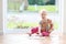 Preschooler girl playing with puzzles on the floor