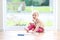 Preschooler girl playing with puzzles on the floor