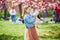 preschooler girl in tutu skirt enjoying nice spring day in cherry blossom garden