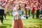 preschooler girl in tutu skirt enjoying nice spring day in cherry blossom garden