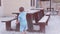 Preschooler kids, siblings playing with white pebbles on the wooden outdoor table