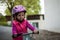 Preschooler learning to balance on bicycle in safe helmet