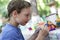 Preschooler painting clay figure