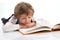 Preschooler reading book while lying on the floor