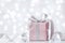 Present or gift box against bokeh background. Holiday greeting card on Birthday or Christmas.