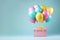 Present pink gift box with festive helium balloons bunch on minimal teal background