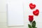 Present red rose flower and notebook and heart shape with copy space on wooden table
