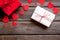 Present to a lover on Valentine`s Day. Gift boxes near paper hearts on dark wooden background top-down frame copy space
