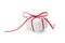 Present wrapped in white paper and tied with red ribbon