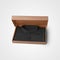 Presentation mockup of black textured polo, folded in a box, for design