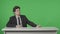 Presenter Reporting. Anchorman corrects the sheets of paper, Talks, Listens, Nods against the background of a green