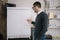 Presenter standing in front of a blank paper whiteboard