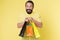 Presents make life more interesting. Man mature bearded cheerful face holds shopping bags. Man got unexpectable gifts