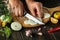 Preservation of tomatoes in a jar for the winter. The chef cuts the onion with a knife on the kitchen cutting board. Peasant food