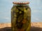 Preservations, conservation Salted pickled cucumbers in a jar on an wooden table