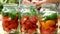 Preservations, conservation Salted pickled tomatoes in a jars on an wooden table