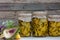 Preserved artichokes in olive oil in glass jars on wooden background. Autumn vegetables canning. Healthy homemade food