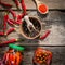 Preserved chili in glass jars on wooden table