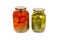 Preserved, pickled tomatoes and cucumbers in a glass jar isolated