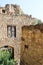 Preserved wall with the window in ruined house of abandoned ancient village Gamsutl in the Dagestan, Russia